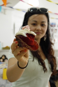 My beautiful sister whom I love dearly (another story) modelling a scrumptious red velvet cupcake made by J. Weurtz